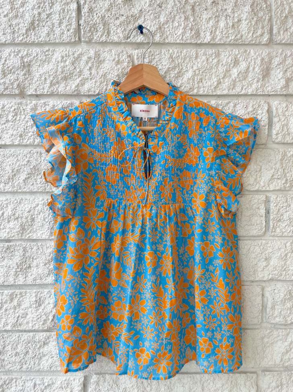 XiRENA Blue Floral Top with Orange Print and Ruffle Sleeves - Picture 1 of 4